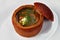 Restaurant food. Rustic closeup of red the soup in bread on white background