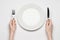 Restaurant and Food theme: the human hand show gesture on an empty white plate on a white background in studio isolated top view