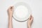 Restaurant and Food theme: the human hand show gesture on an empty white plate on a white background in studio isolated top view