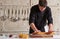 Restaurant hotel private chef preparing pizza rolling flattening