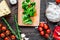 Restaurant kitchen with pizza preparing on wooden background top