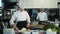 Restaurant Kitchen: Portrait of Male and Female Chefs Preparing Dish. Two Professionals Cooking Delicious, Authentic Food, Healthy