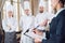 Restaurant manager and his staff in kitchen. interacting to head chef in commercial kitchen