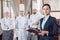 Restaurant manager and his staff in kitchen. interacting to head chef in commercial kitchen