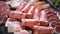 Restaurant meat platter ham, salami, bacon on the black stone tray