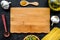 In restaurant. Mock up for menu or recipe. Wooden cutting board near ingredients. Raw pasta, oil, garlic, spices on