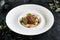 Restaurant Plate of Beef Cheeks in Cherry Glaze with Potato-Celery Cream and Sauce of Dried Berries