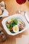 Restaurant serving salad with cheese, tomatoes and herbs