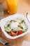 Restaurant serving salad with cheese, tomatoes and herbs