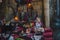 The restaurant set table with Burgundy chairs and a tablecloth. On the table forged stands for flowers and candles. Dark