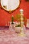 Restaurant table at Christmas. Candlesticks or candleholders and candles, tiny Christmas trees or firs and many wine glasses. A