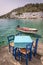 Restaurant tables by the sea in the scenic village of Loutro in Crete Greece