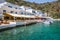 Restaurant terraces by the sea in the scenic village of Loutro in Crete, Greece