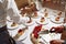 Restaurant waiters cutting sweet cake into pieces for serving guests on holiday. Hands close up view