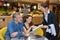 Restaurant waitress giving menu to customers