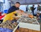 Restaurant workers open the shells of fresh oysters in the Berga Bazaar restaurant