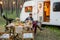 Restful guy playing guitar by served table