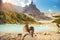 Resting with boots legs crossed near Lago di Sorapis, Dolomites, Italy with blue sky, azure water and high mountains in the