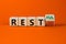Restless or restful symbol. Turned the wooden cube, changed the word `restless` to `restful`. Beautiful orange table, orange