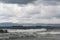 Restless stormy sea. Summer clouds are cool day. Cargo ships are in the distance.