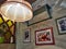 Restorant interior decoratiing arrangement with lamp and paintings