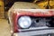 Restoration of classic car. Close up view front side classic car, front headlight of a broken dusty car during road