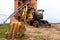 Restoration of the Novogrudok castle in Novogrudok. Builders and an excavator at a construction site near a historic building