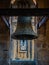 Restored bronze bell but with pigeon poop from the bell tower of the Clerecia church in Salamanca, protected with iron beams and