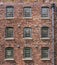 Restored industrial cotton mill with pattern of windows