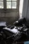 Restored Norton motorcycle in shadow with faded painted window at Chateau de Savigny near Beaune in Burgundy, France