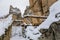 Restored oak wood draw-well winch, ancient ruins of old gothic medieval castle Helfenburk u Usteka tower under snow in winter day