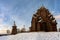 Restored orthodox wooden Twenty-five-headed Church of the Intercession of the Blessed Virgin Pokrovskaya at sunny winter day. St.