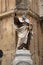 Restored and painted statue of a saint in the niche of limestone corner house in Valetta, Malta