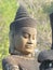 Restored statue of a god on the causeway to Angkor Thom`s south gate