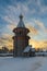 Restored timbered belfry at sunny winter day. St.Petersburg suburb, Russia