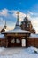 Restored wooden Sacred Gate of the fence of the Spassky country churchyard at sunny winter day. St.Petersburg suburb, Russia