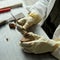 A  restorer of fine arts cleaning the antique ceramic with scalpel