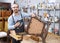 Restorer holding tools in woodwork studio