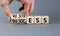 Restress for success symbol. Concept words Restress and Success on wooden cubes. Businessman hand. Beautiful grey table grey