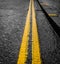 Restricted Parking, Close Up of Bright Double Yellow Lines on a Wet and Rainy Day - Norwich, UK