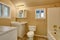 Restroom interior with beige walls. Refreshing white vanity cabinet