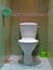 Restroom with white ceramics toilet, water closet aka lavatory room, everyday sanitary, hygiene, hygienics, marble floor,