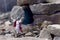 Resurrected Jesus Christ standing in front of the entrance to the grave - tomb. He stands among the rocks.