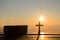 Resurrection of Jesus Christ concept: Silhouette cross with bible on hill sunrise background