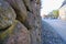 Retaining wall and pavement made of granite cobblestones in a European city. perspective street view