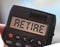 Retire word on calculator display. Retirement career business concept