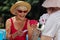 Retired bearded man wearing white shirt playing cards with wife