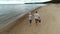 Retired caucasian couple on weekend walking on beach together.