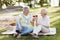 Retired couple enjoying picnic and weather in the park