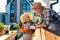 Retired couple looking at little blue flower pot while planting flowers